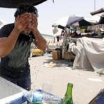 A man washed his face to cool off during a warm summer day in Baghdad last July.