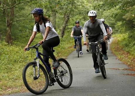 President Barack Obama trailed his daughter, Malia, as the family took a bike ride on Martha's Vineyard on Saturday. 
