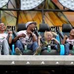 Eunice Arias Soto, left, and Juan Beras are joined by their daughter, Maria Beras, 10, and family friend Layla Smith, 6, while enjoying a ride on the Seven Seas at the Marshfield Fair on Aug. 21. The fair runs through Aug. 30. (Craig F. Walker / Globe Staff)