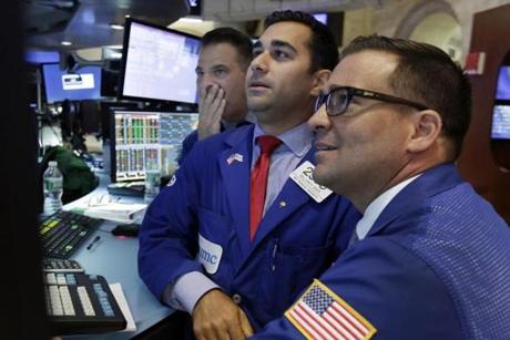 A trio of specialists looked at a screen at a post on the floor of the New York Stock Exchange on Tuesday.
