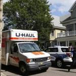 Brighton, Massachusetts -- 09/01/2014-- A police officer directs UHauls during college move in day in Brighton, Massachusetts September 1, 2014. Jessica Rinaldi/Globe Staff Topic: feature Reporter: 