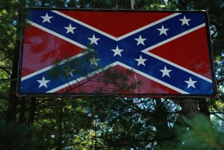 The Confederate flag was erected about five years ago by a 1969 Walpole High graduate whose property abuts Turco Field.
