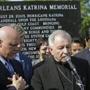 New Orleans Archbishop Gregory Aymond delivered a eulogy, flanked by New Orleans Mayor Mitch Landrieu, left, and Louisiana Governor Bobby Jindal, at the Hurricane Katrina Memorial.