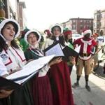 8/31/2015 - Allston, MA - From left: Joshua Collier, cq; Amal El-Shrafi, cq; Sarah Morrow, cq; and Britt Brown, cq; all singers with Olde Towne Carolers, cq, were hired by BFresh, a new grocery store that is opening in Allston, along with Christams-costumed pedicab drivers to entertain and serenade students during move in day, also known as 