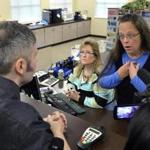 Rowan County Clerk Kim Davis (right) told license-seeker David Moore she was acting ?under God?s authority? Tuesday.