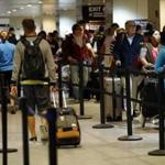 Last month, passengers queue in line at customs inside Logan Airport's International Terminal in Boston. 