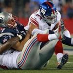 Patriots quarterback Ryan Lindley is sacked in the second quarter by George Selvie (bottom) and former Boston College star Mark Herzlich.