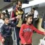 A refugee family arrive at the Westbound Railway Station in Vienna on Saturday after having earlier been transported by coach from the Hungarian border.