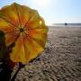 Jose Triana, of Walpole, closed his umbrella after spending the day at Mayflower Beach.