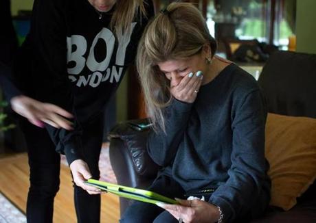FILE - In this Thursday, Sept. 3, 2015 file photo, Tima Kurdi is overcome with emotion as she looks at photos of her late nephews Alan and Galib Kurdi, at her home in Coquitlam, British Columbia, Canada. The body of 3-year-old Syrian, Alan, was found on a Turkish beach after the small rubber boat he, his 5-year old brother Galib and their mother, Rehan, were in capsized during a voyage from Turkey to Greece. The family said the spelling of the boys' names had been changed by Turkish authorities to 