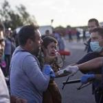 A man held his child as he tried to talk to Hungarian police officers in Roszke in southern Hungary.