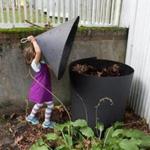 Abby Edelstein, 5, closed the lid on her back yard compost pile in Newton.