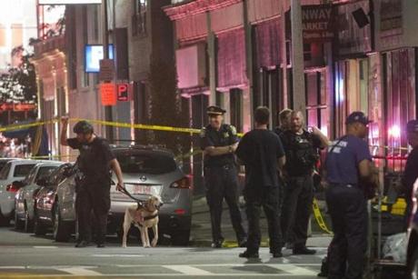 A police officer and his dog entered a cordoned-off area on Tuesday. 
