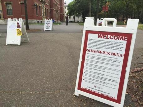 Signs in Harvard Yard provide guidelines to visitors and tourists.
