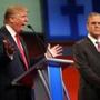 Republican presidential candidate Donald Trump speaks as Jeb Bush watches during a Republican presidential debate in Cleveland on Aug. 6, 2015. 