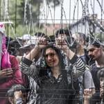 Migrants and refugees stood behind a fence at the Hungarian border with Serbia.