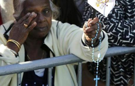 A woman held a rosary outside the White House.
