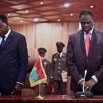 Michel Kafando (right) was formally returned to power as president of Burkina Faso amid cheers while flanked by President Thomas Boni Yayi of Benin (left) and other leaders.