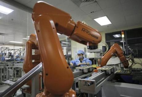 Robot arms at work in a factory in China.
