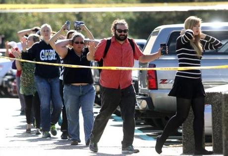 Students, staff and faculty are evacuated from Umpqua Community College in Roseburg, Ore. after a deadly shooting on Thursday.
