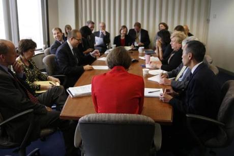 Maura Healey (center) met with her staff in Boston. 
