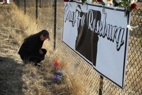 Robin Griffiths of Portland, Ore., prayed Saturday at a makeshift memorial near Umpqua Community College
