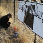 Robin Griffiths of Portland, Ore., prayed Saturday at a makeshift memorial near Umpqua Community College