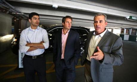 SpotLight Parking CTO Karan Singhal (left) and CEO Mike Miele (center) listen to Kevin J. Leary, president of VPNE. 
