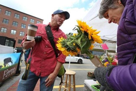 Chris Masci, owner of New England Open Markets, chatted with Barbara Rietscha, owner of Stow Greenhouses. The South End Open Market at SoWa will move to a new location next year. 
