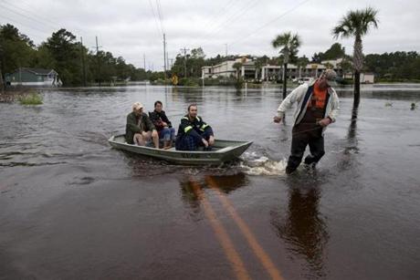 David Carroll (right) pulled boat carrying neighbors in Conway, South Carolina.

