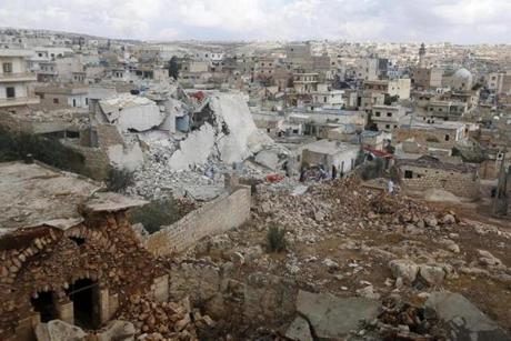 People inspected a site hit by what residents said were airstrikes carried out by the Russian air force in the town of Darat Izza in Aleppo's countryside. 
