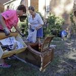 Linda Whitcomb (left) helped Dot Valentine go through the belongings of her flooded home in Columbia, S.C., on Wednesday. 