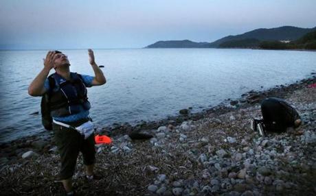 Samer Shkeer, a Syrian refugee, prays after crossing the Mediterranean to the shore of Skala Sykamnia on the island of Lesbos, Greece, on Sept. 11. 
