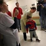 Christian Caruso, 4, got assistance from his physical therapist, Colleen Farrell, as he left the hospital while staff blew bubbles for him. 