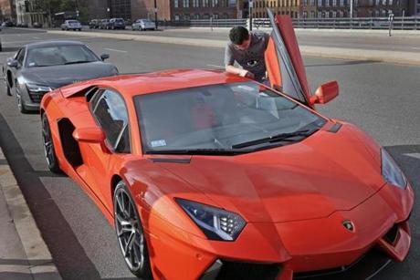 A student, who did not want to be identified, said he owns this orange Lambor-ghini and the Audi R8 Spyder behind it.
