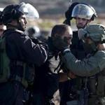 Israeli policemen detained a Palestinian protester during clashes near the Jewish settlement of Bet El in the West Bank.