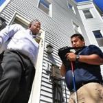 Landlord Allen Mathurin (left) had his apartment inspected by Marcio Fonseca Jr. of the city?s Inspectional Services.
