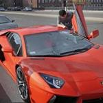 A student, who did not want to be identified, said he owns this orange Lambor-ghini and the Audi R8 Spyder behind it.
