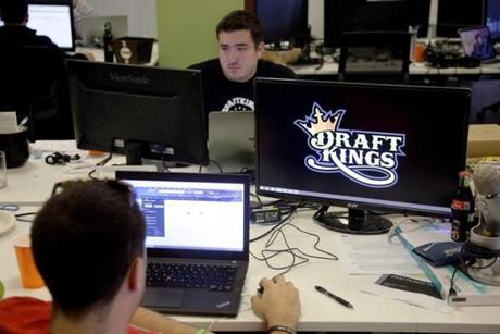 FILE- In this Sept. 9, 2015, file photo, Len Don Diego, marketing manager for content at DraftKings, a daily fantasy sports company, works at his station at the company's offices in Boston. New York's attorney general has sent letters to daily fantasy sports websites DraftKings and FanDuel demanding they turn over details of any investigations into their employees on Tuesday, Oct. 6, 2015. (AP Photo/Stephan Savoia, File)
