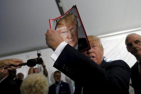Donald Trump held up the cover of Time magazine with his portrait at a campaign fundraiser at the home of car dealer Ernie Boch Jr. in Norwood.
