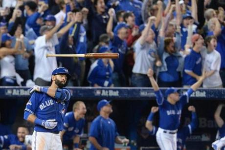 Toronto Blue Jays' Jose Bautista tosses his bat after hitting a three-run home run during the seventh inning in Game 5 of baseball's American League Division Series, Wednesday, Oct. 14, 2015 in Toronto. The Toronto Blues Jays beat the Texas Rangers 6-3. (Chris Young/The Canadian Press via AP) MANDATORY CREDIT
