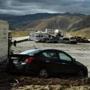 Vehicles were stuck on a road after being trapped by a mudslide on California Highway 58 in Mojave, Calif.