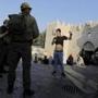 Israeli police checked a Palestinian man at the the Damascus Gate in Jerusalem's Old City on Saturday. 