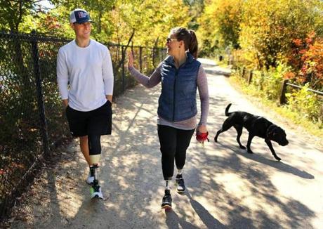 Patrick Downes and Jess Kensky walked around Fresh Pond with their dog, Rescue.
