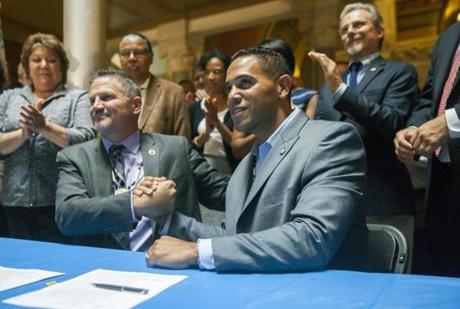 Kevin Brown, left, Chairman of the Mohegan Tribal Council and Rodney Butler, right, chairman of the Mashantucket Pequot Tribal Council, host an historic signing ceremony, Thursday, Sept. 10, 2015, at the state Capitol in Hartford, Conn., formalizing their new casino venture north of the city. In an effort to halt an exodus of gamblers and the loss of industry jobs, the tribes, backed by the legislature and Gov. Dannel P. Malloy, hope to compete with the planned MGM Resorts casino in Springfield, Mass. (Lauren Schneiderman/Hartford Courant via AP) MANDATORY CREDIT
