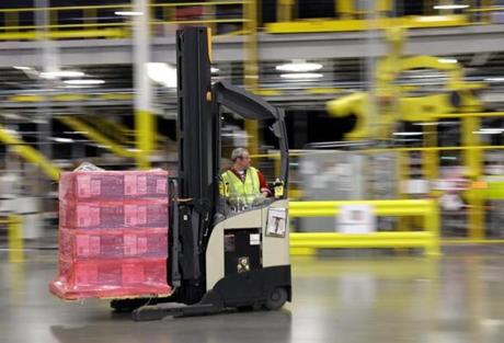 FILE - In this Feb. 13, 2015, file photo, a forklift operator moves a pallet of goods at an Amazon.com fulfillment center in DuPont, Wash. Amazon said Tuesday, Oct. 20, 2015, it will add 100,000 holiday jobs this season across the country in its fulfillment and sortation centers, so that it can meet increased customer demand. (AP Photo/Ted S. Warren, File)

