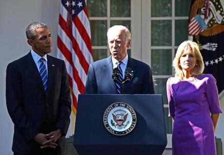 US Vice President Joe Biden (C), flanked by US President Barack Obama (L) and his wife Jill Biden (R), speaks in the Rose Garden at the White House on October 21, 2015, in Washington, DC. Biden announced that he is not running for president. AFP PHOTO / JIM WATSONJIM WATSON/AFP/Getty Images
