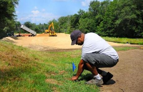 John Thompson checked a sprinkler during the golf course?s restoration in 2014.
