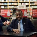 Ben Carson paused before leaving his book signing event at a store in Ames, Iowa on Saturday. 