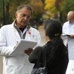 Doctors Vikas Saini (left) and Aaron Stupple wrote down the health care stories that they heard from passersby.